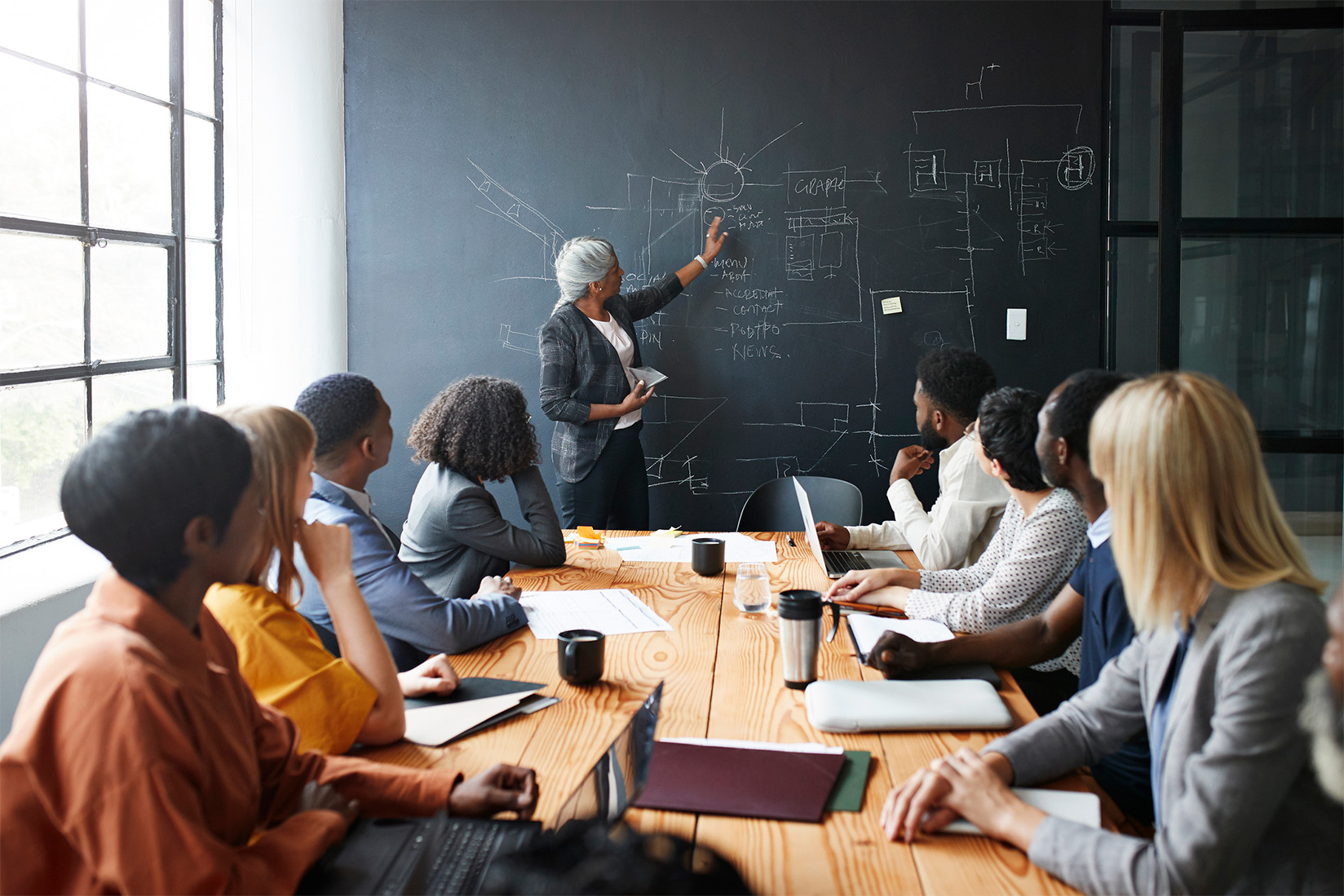 Woman explaining plan to team